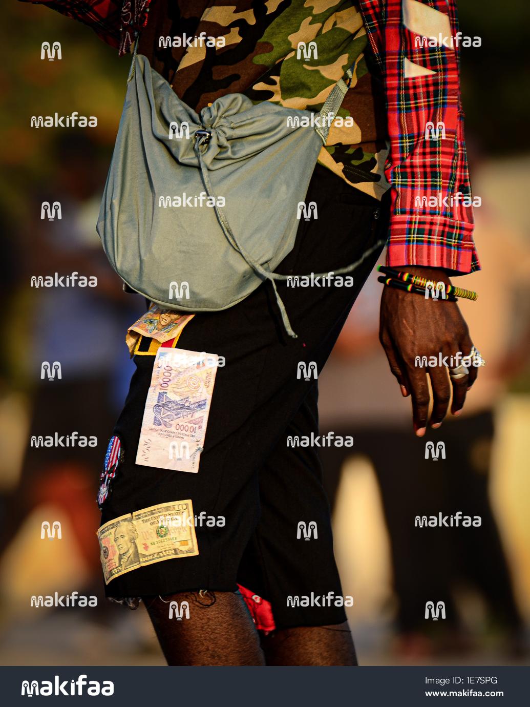 Artistic portrait of a young man with money bills 