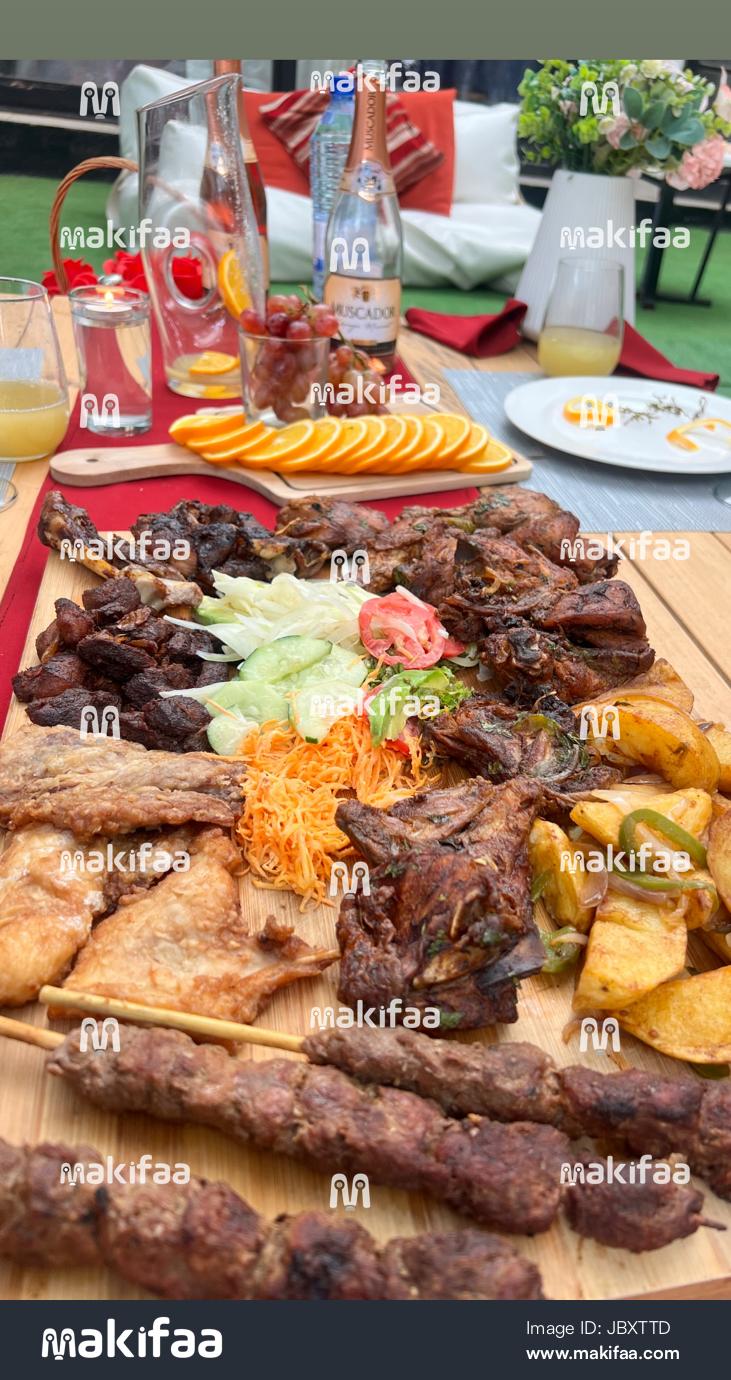 Grilled meat with salad and orange slices 