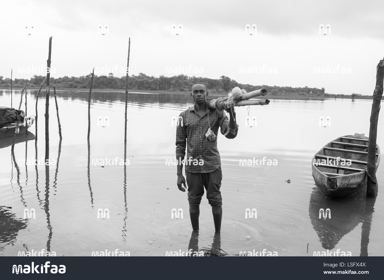 Fisherman standing at the water&#39;s edge 