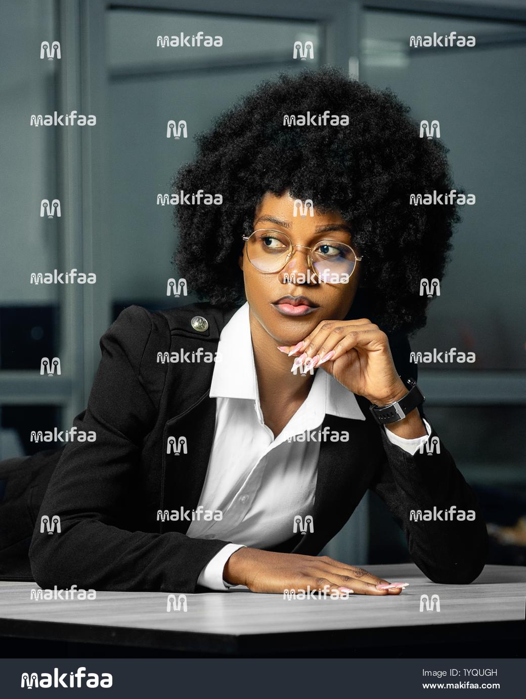 Professional portrait of a woman in an office deep in thought 