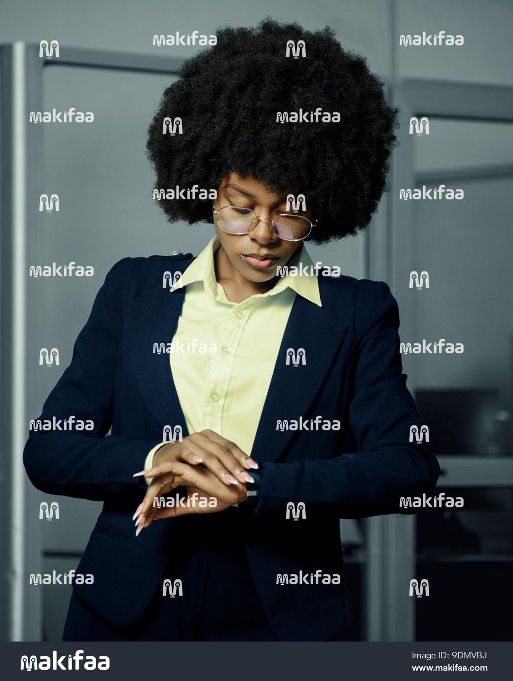 Young woman in a hurry looking at her watch 