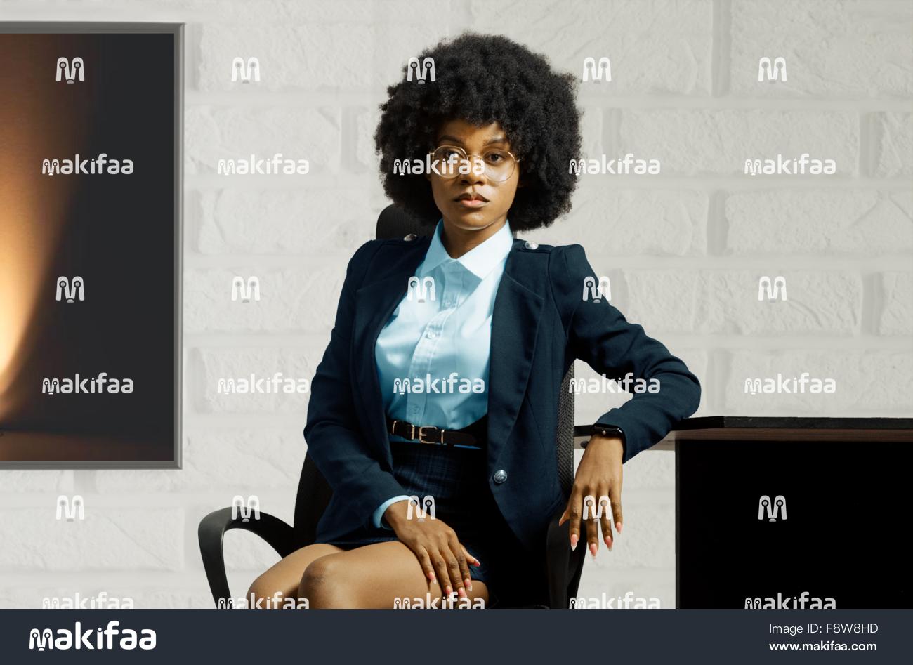 Portrait of a woman in a jacket sitting in an office 
