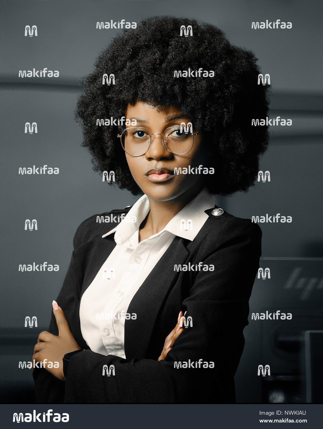 Portrait of a young professional woman with arms crossed in an office 