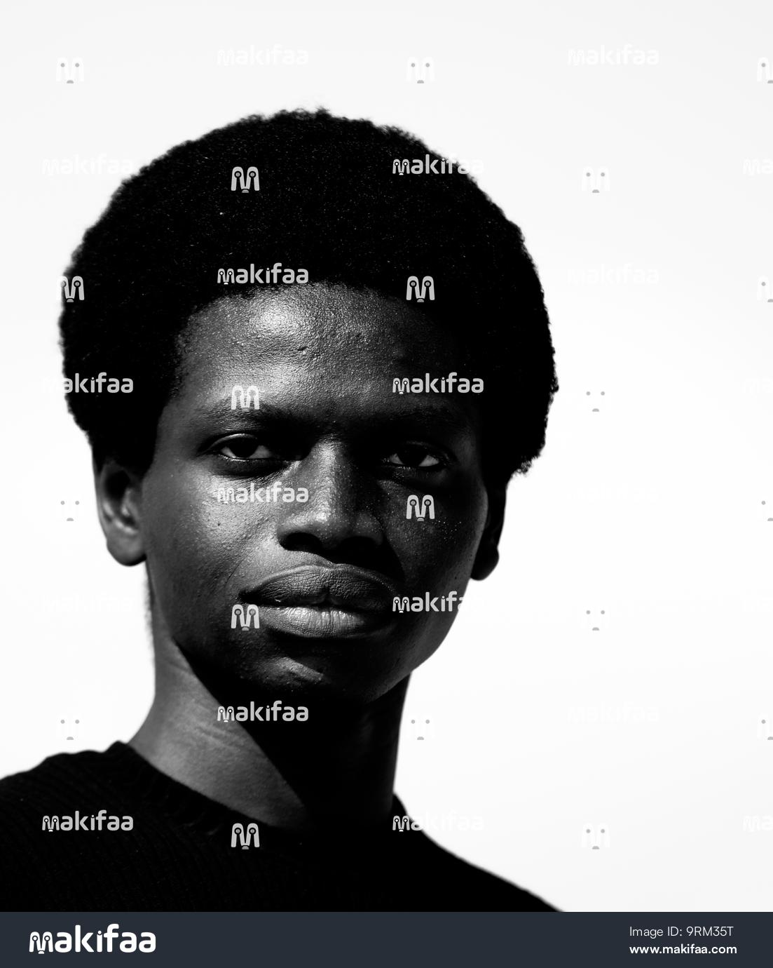 Black and white portrait of a young man with frizzy hair 