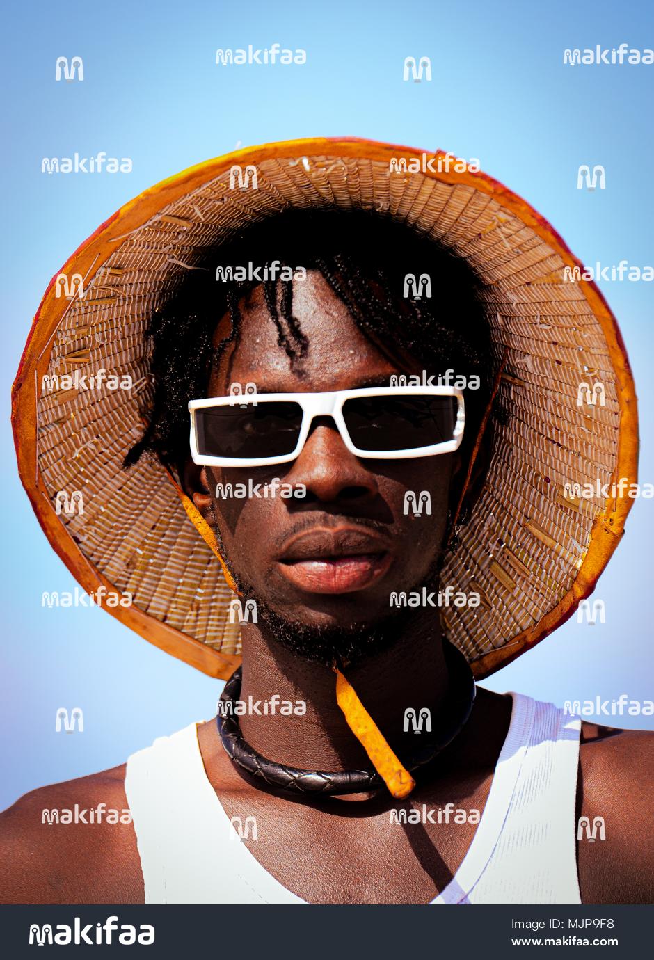 Young man with hat and glasses in casual look 