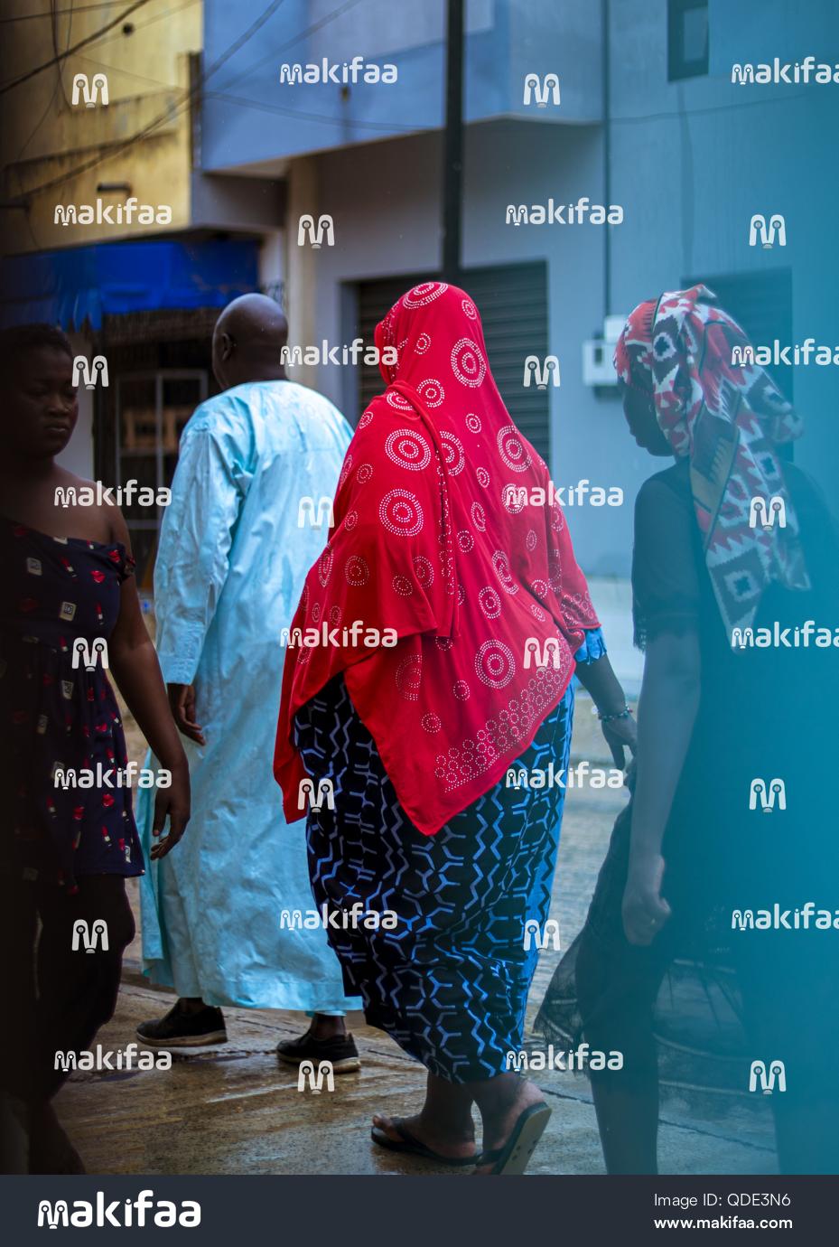 Group of elderly people walking on the street in the rainy season