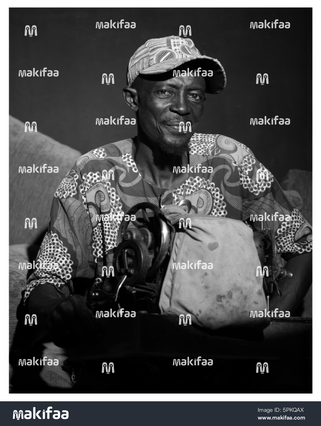 An old man with a sewing machine 