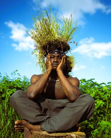 A man in a boubou performing a leap towards the sky