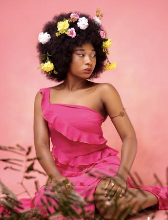 African Stylish portrait of a woman with afro hair posing sensually 