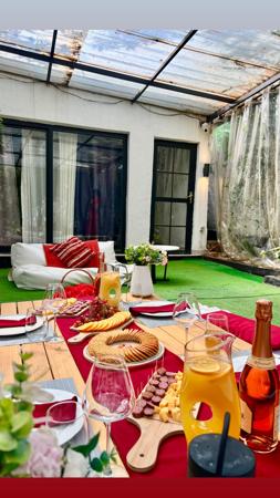 An arranged outdoor table with snacks, wine and juice