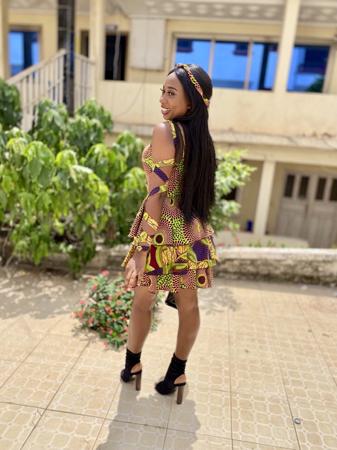 Beautiful Lady smiling in Ankara dress.