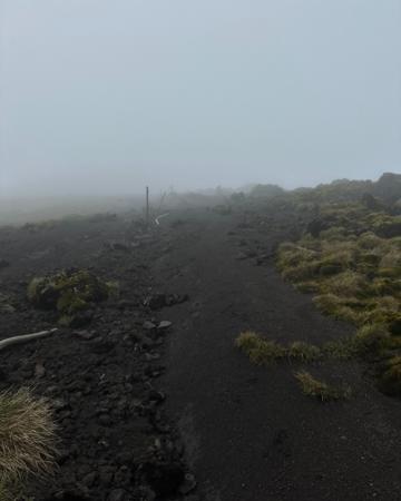Fog above volcanoes with rugged lava stones