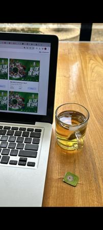 Green tea in Elegant glass Beside laptop