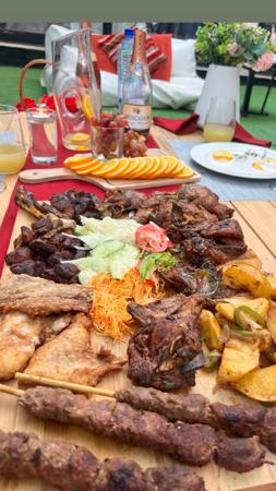 Grilled meat with salad and orange slices