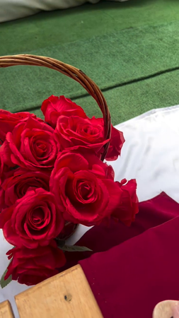 Outdoor dining steup with red flowers 