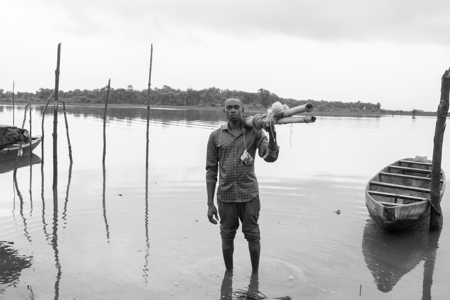 Fisherman standing at the water's edge