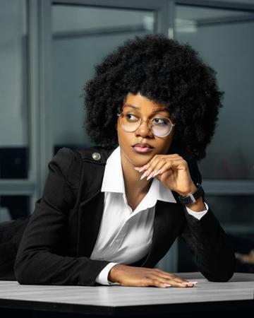 Professional portrait of a woman in an office deep in thought 