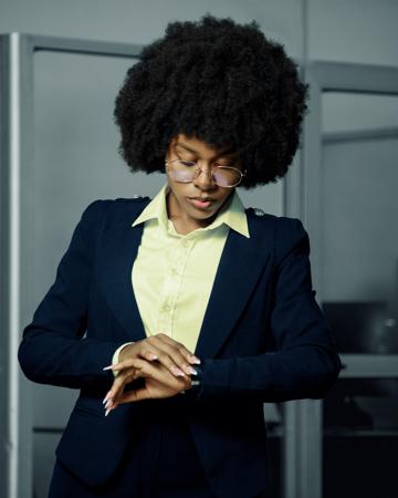 Young woman in a hurry looking at her watch 