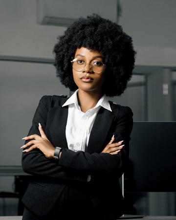 Professional portrait of a woman in a jacket with her arms crossed in an office 