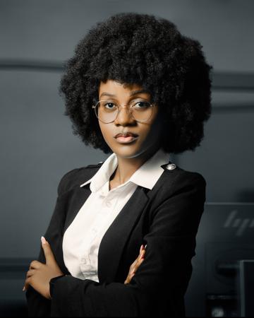 Portrait of a young professional woman with arms crossed in an office 