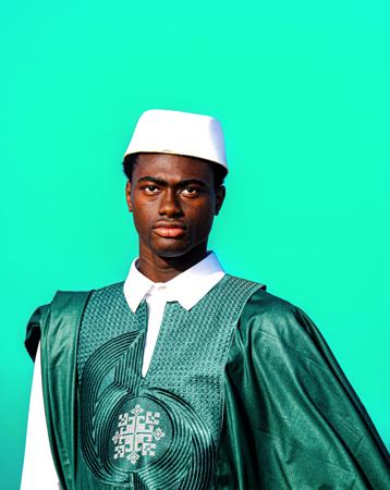 Studio portrait of a young man in a traditional green boubou 
