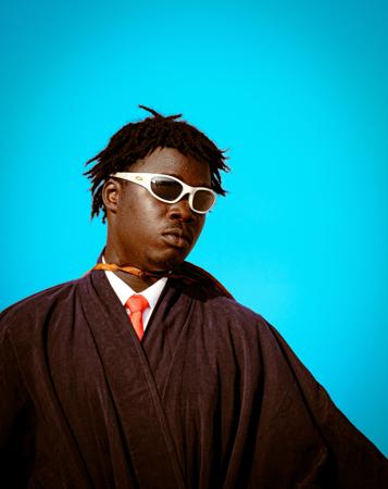 Home wearing glasses posing for a magazine