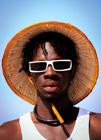 Young man with hat and glasses in casual look 