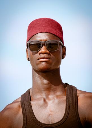 Portrait of a young man in a tank top with an optimistic look 