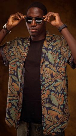 Young man adjusting his sunglasses