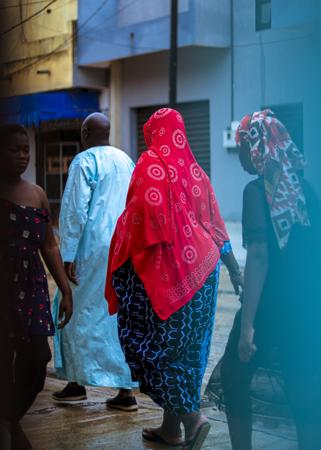 Group of elderly people walking on the street in the rainy season