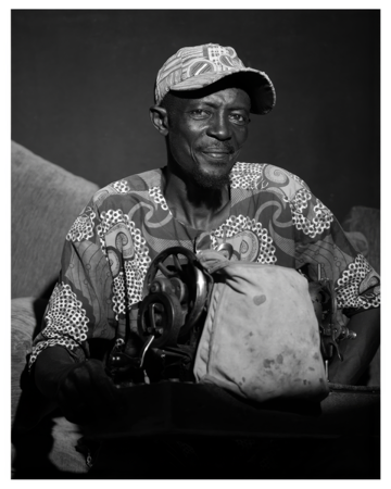 An old man with a sewing machine